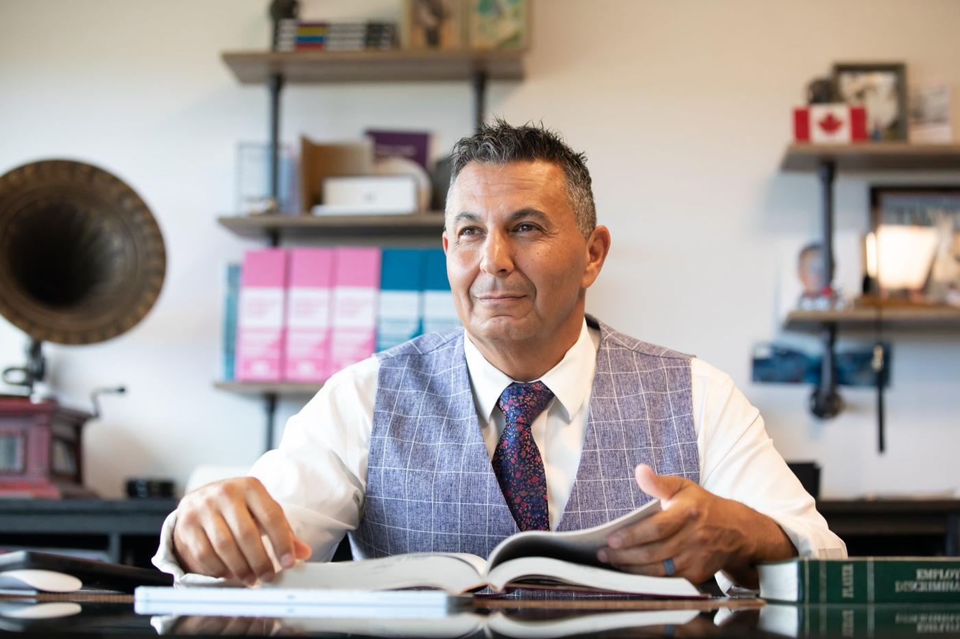 Andrew Obeidy working in the firm's office